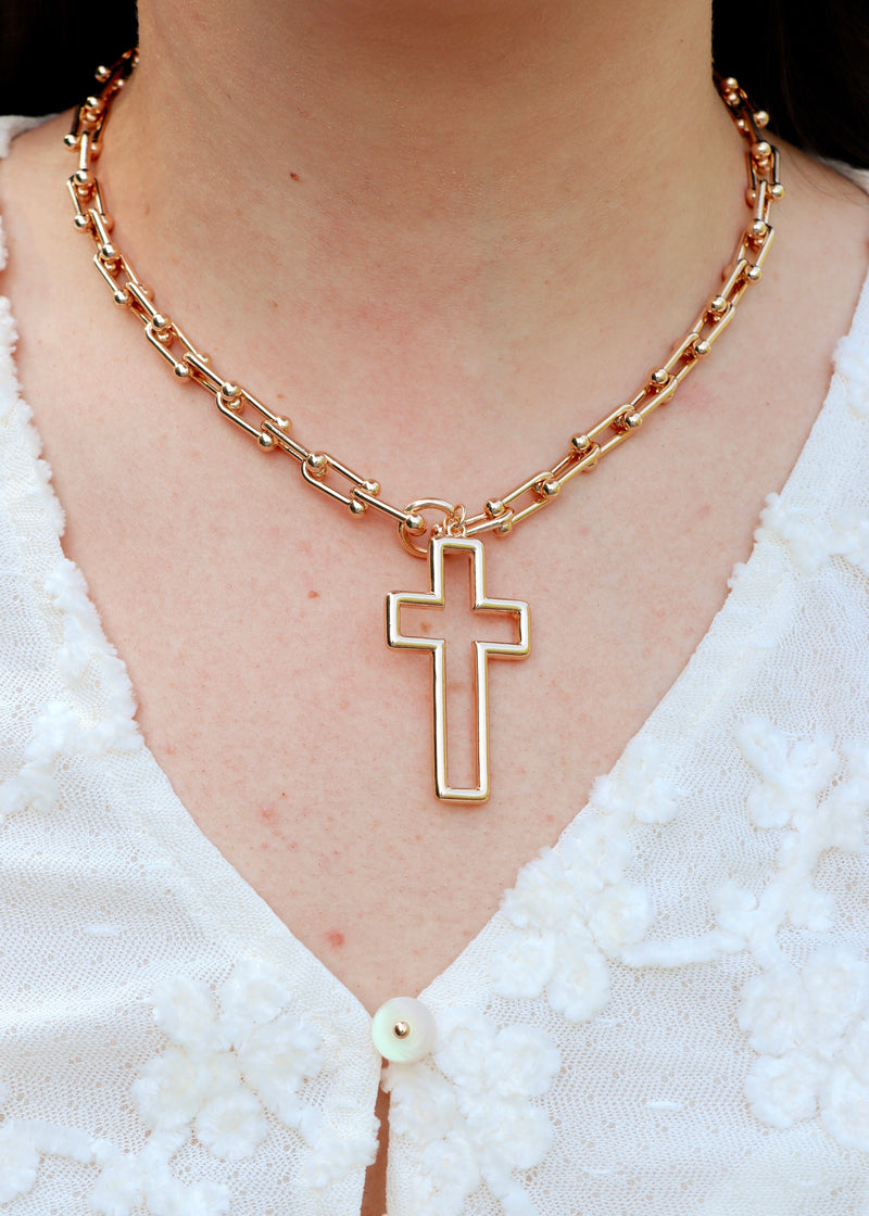 Gold Cross Necklace On White Textured Top