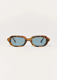Sunglasses with tortoiseshell frame and blue lenses on a white background