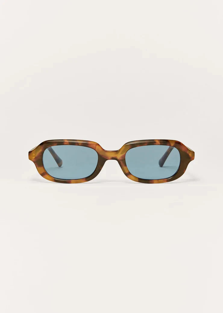 Sunglasses with tortoiseshell frame and blue lenses on a white background
