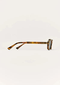 Tortoiseshell sunglasses on a light gray background