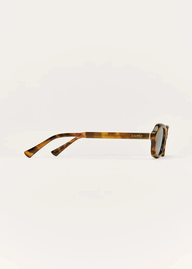 Tortoiseshell sunglasses on a light gray background
