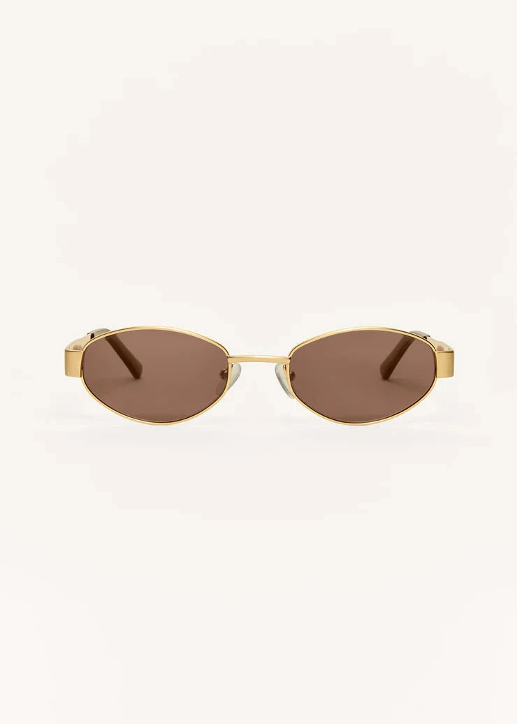 Gold-framed sunglasses with brown lenses on a white background