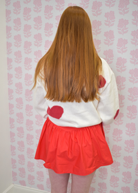 Back of Cream knit sweater with playful red hearts and relaxed fit