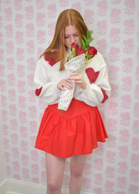 Effortless cream sweater with red hearts for cozy seasonal outfits