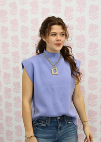 Close up of mock neck detail on baby blue sleeveless knit top