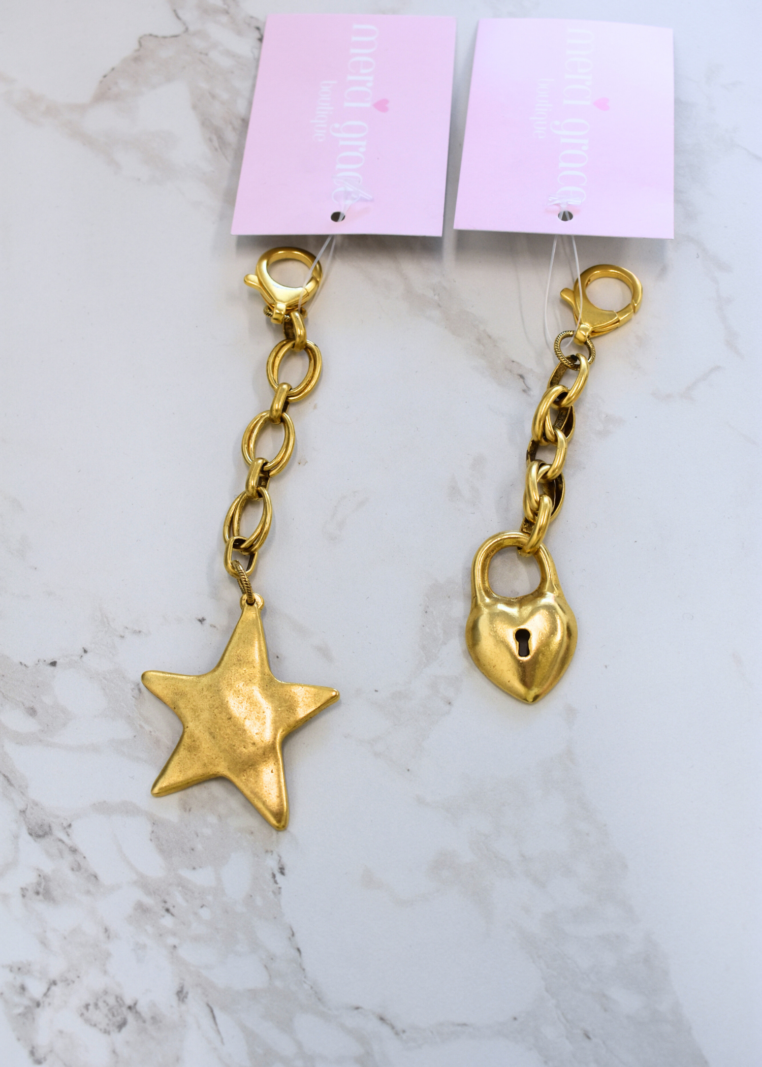Two shapes of bag charms in star and heart locket