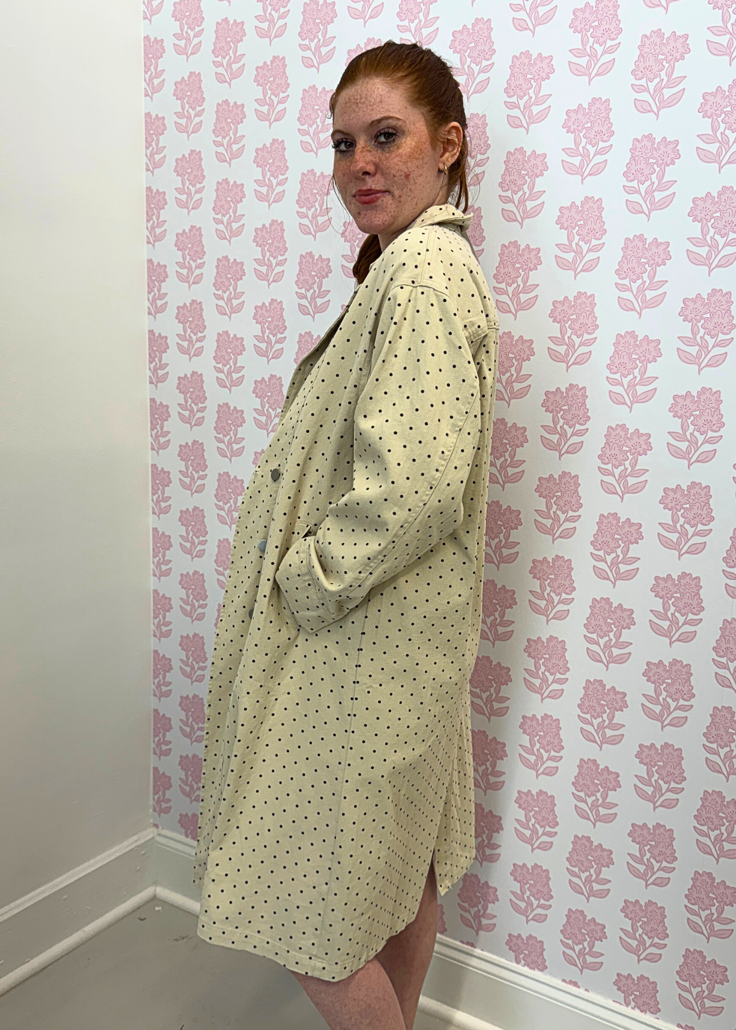 Side view of polka dot denim trench coat in beige