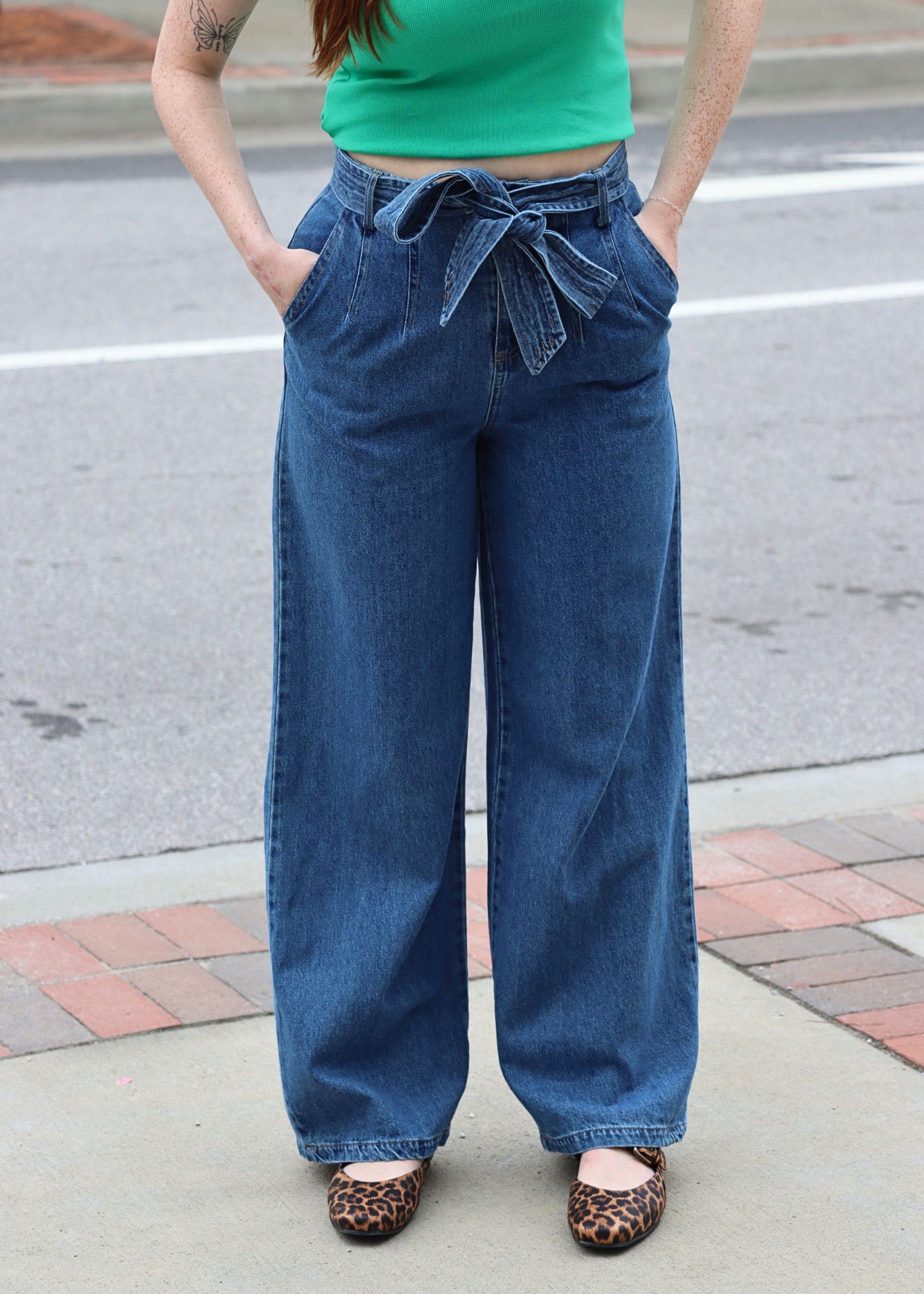 Front view of belt detail high rise wide leg denim pants in dark wash