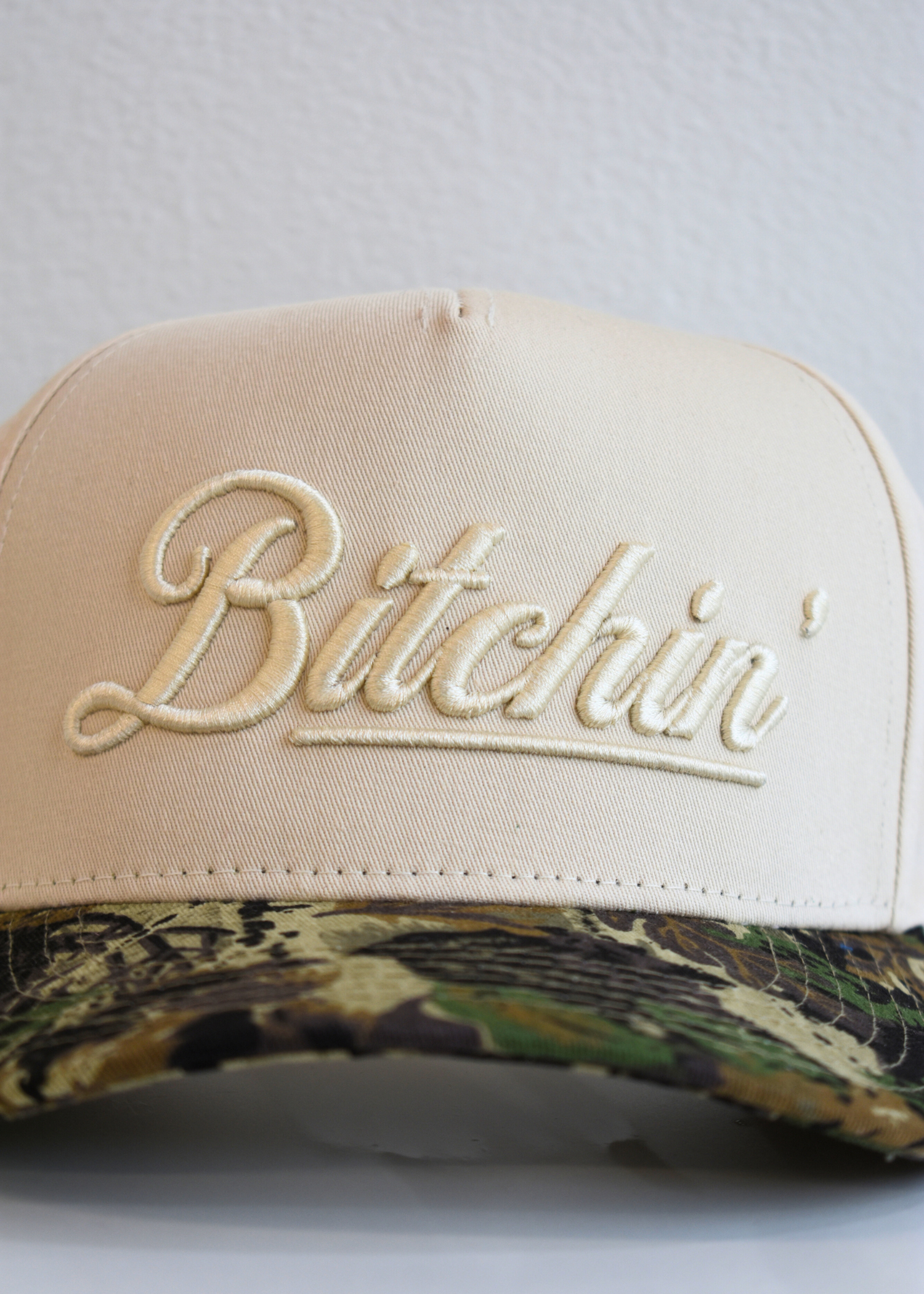 Detail view of Bitchin camo and natural vintage trucker hat