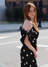 Side view of satin polka dot bias cut dress with asymmetrical strap