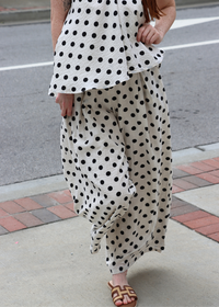 Close up of polka dot print on lightweight linen pants