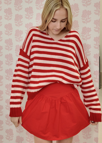 Blush and scarlet striped sweater with flattering v neck silhouette