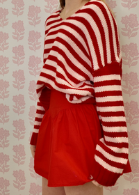 Soft knit pink and red striped sweater styled for everyday wear