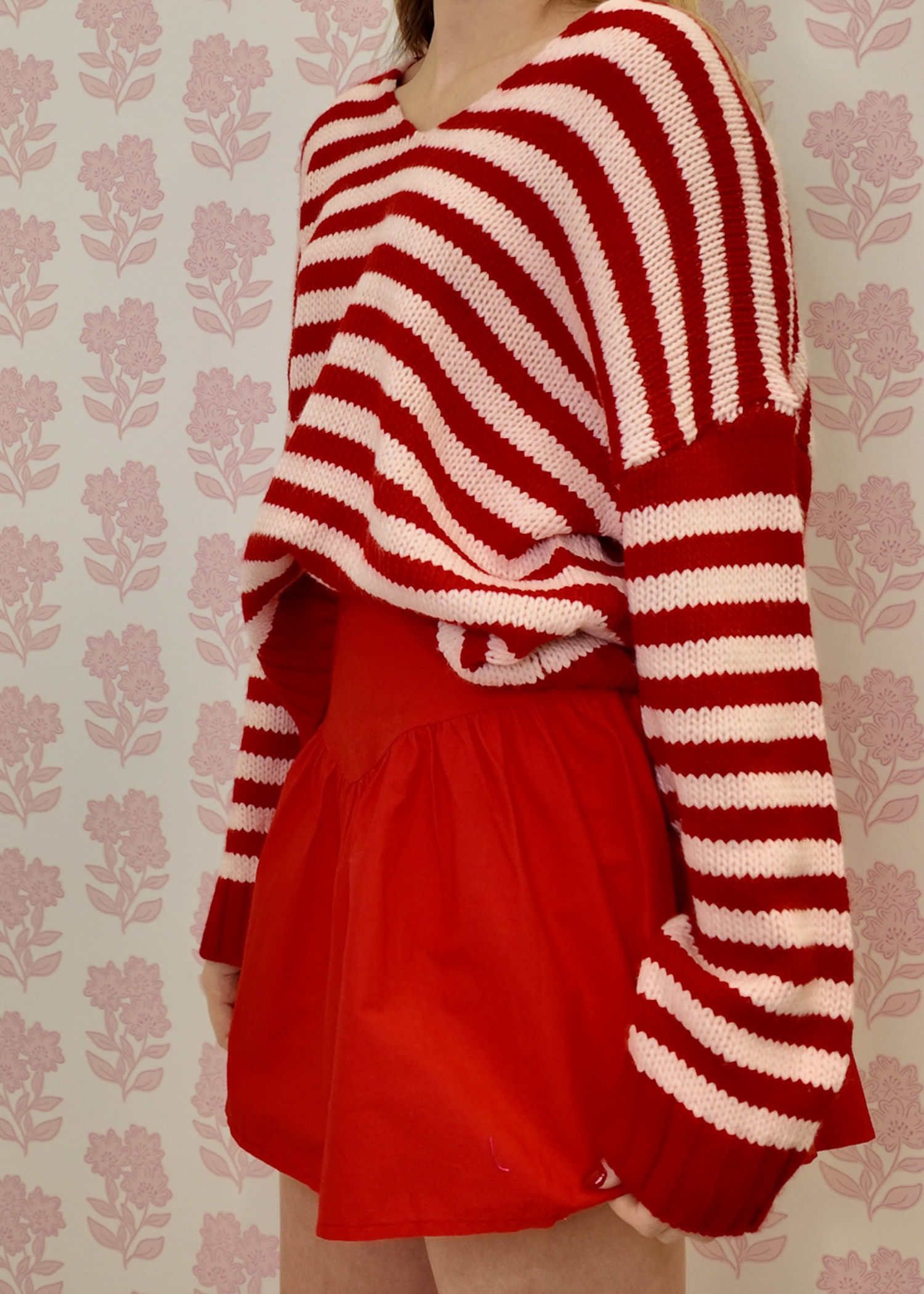 Soft knit pink and red striped sweater styled for everyday wear