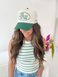 Women’s green faith based trucker hat styled with casual boutique outfit