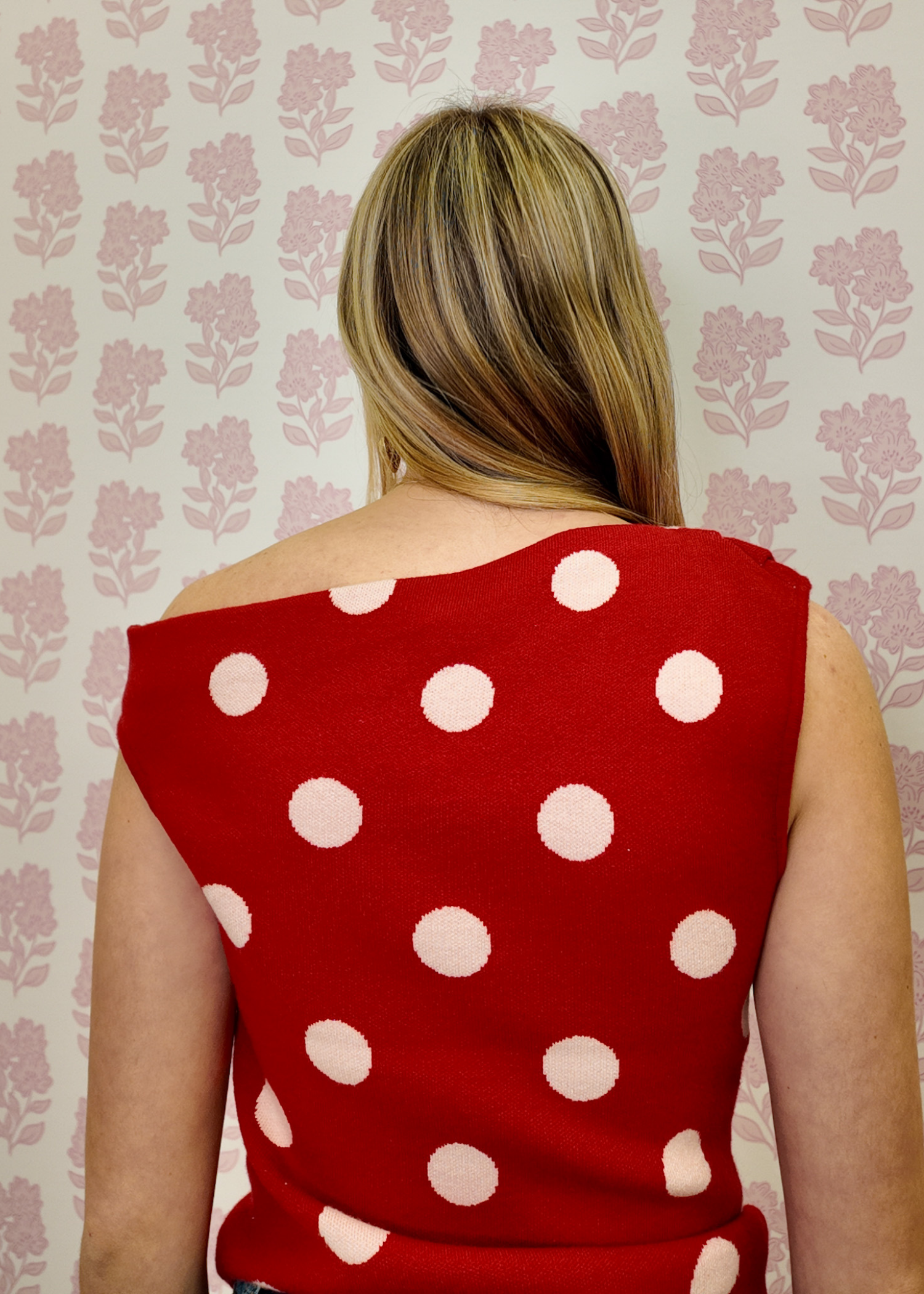 Camille red and white polka dot sweater featuring an asymmetrical neckline