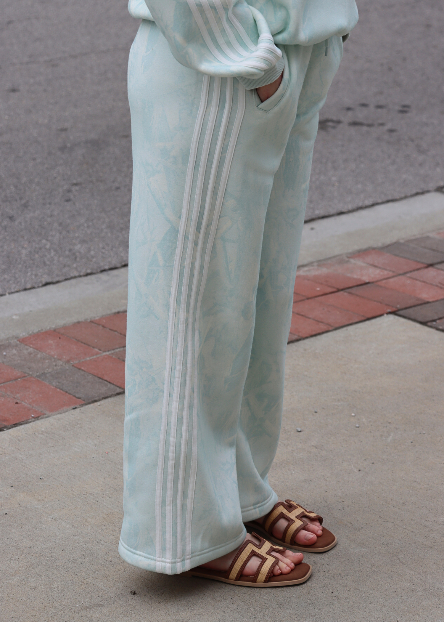 Close up of mint camo print and side stripe detail on sweatpants