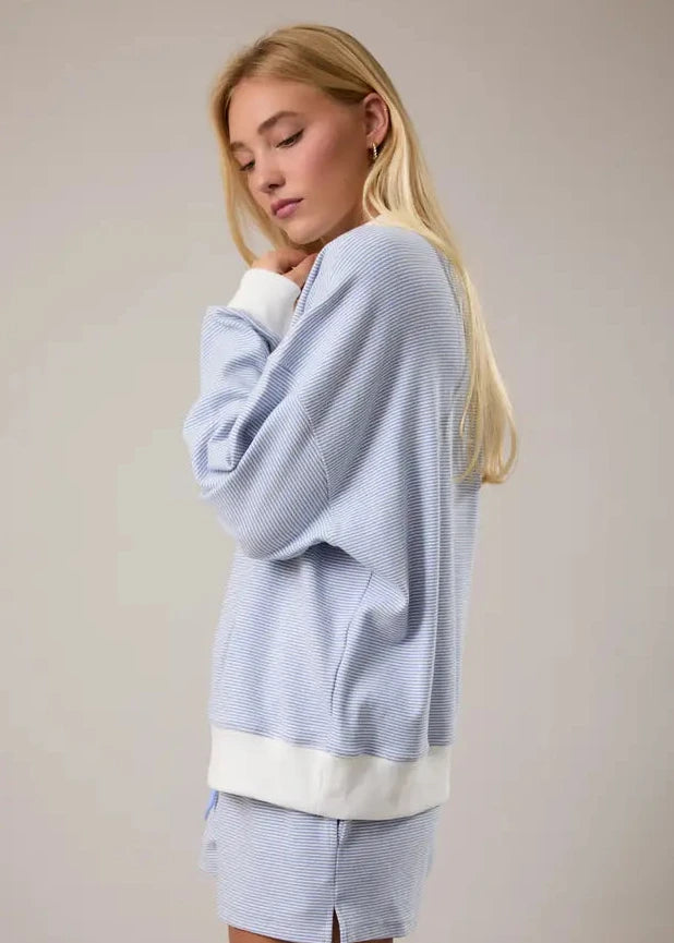 Side view of women’s cotton blend striped mock neck pullover