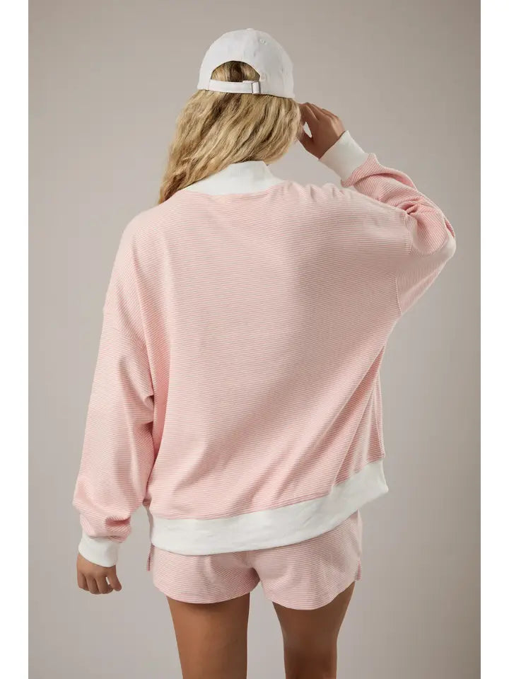 Neutral peach and cream mock neck sweatshirt for laid-back outfits