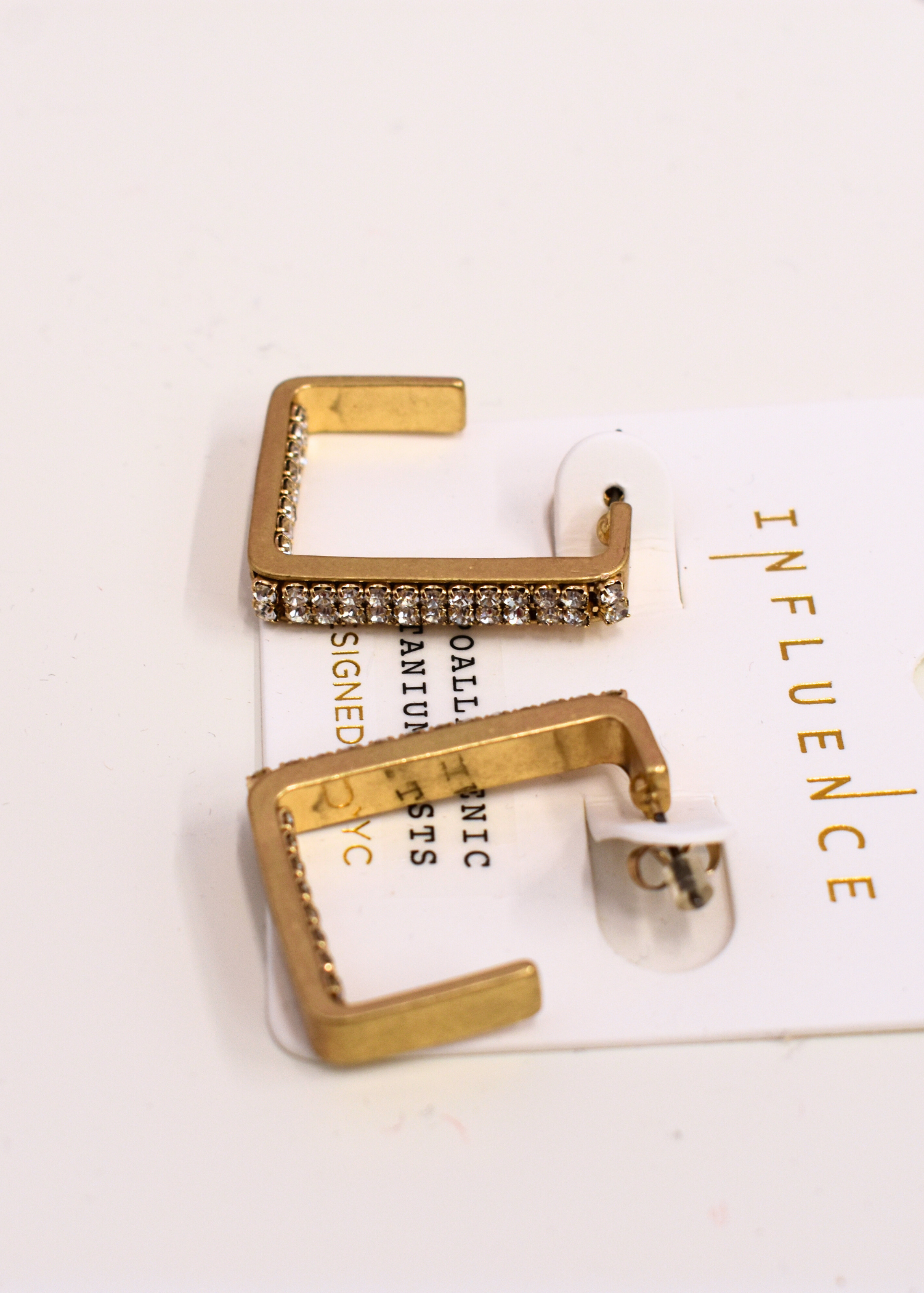 Geometric gold hoop earrings with crystal accent detail