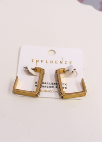 Gold crystal hoop earrings styled for everyday wear