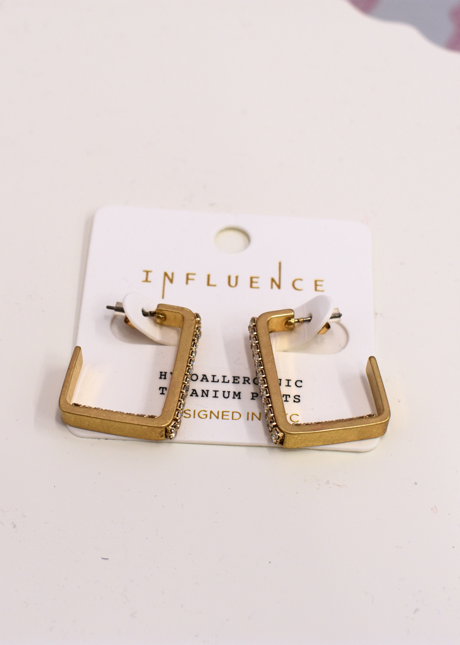 Gold crystal hoop earrings styled for everyday wear