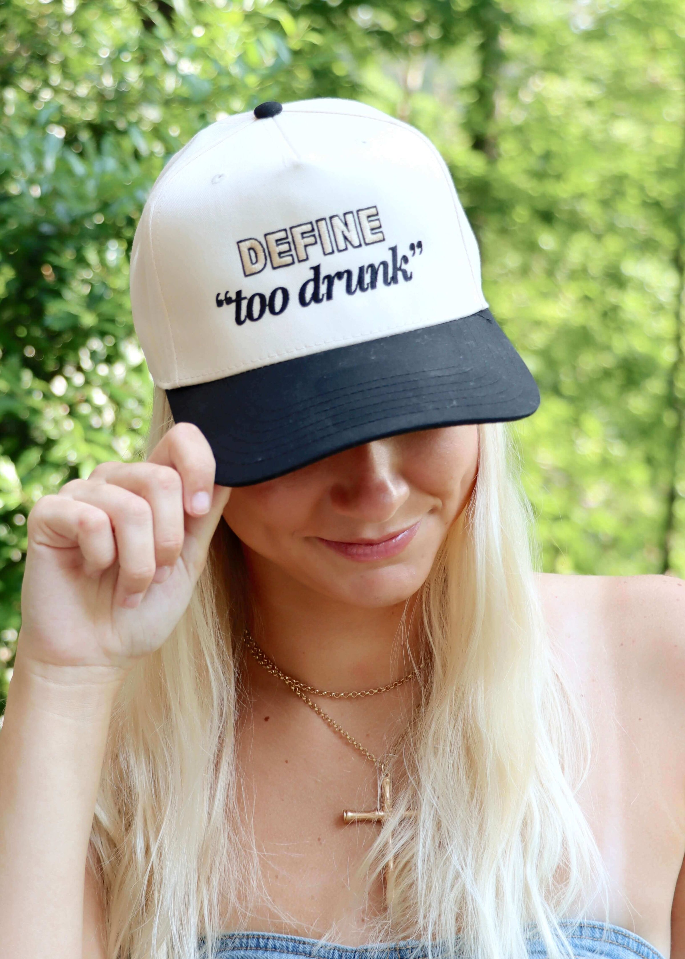 Front view of Define Too Drunk black and natural vintage trucker hat