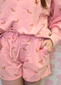 Close up of dachshund print on pink sweatshort lounge set