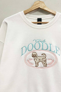 Close up of embroidered doodle dog design on sweatshirt
