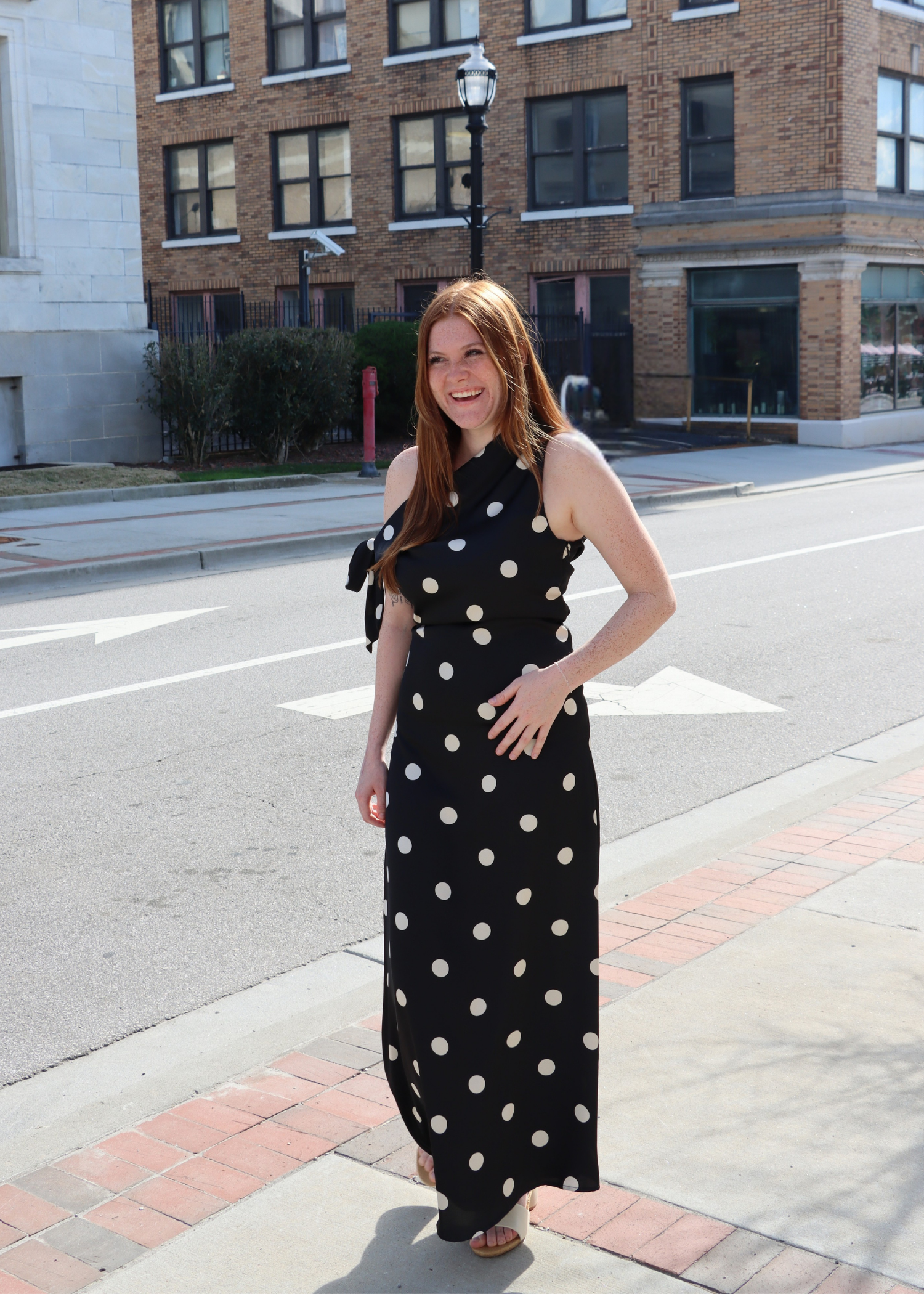 Black satin polka dot dress styled as wedding guest outfit