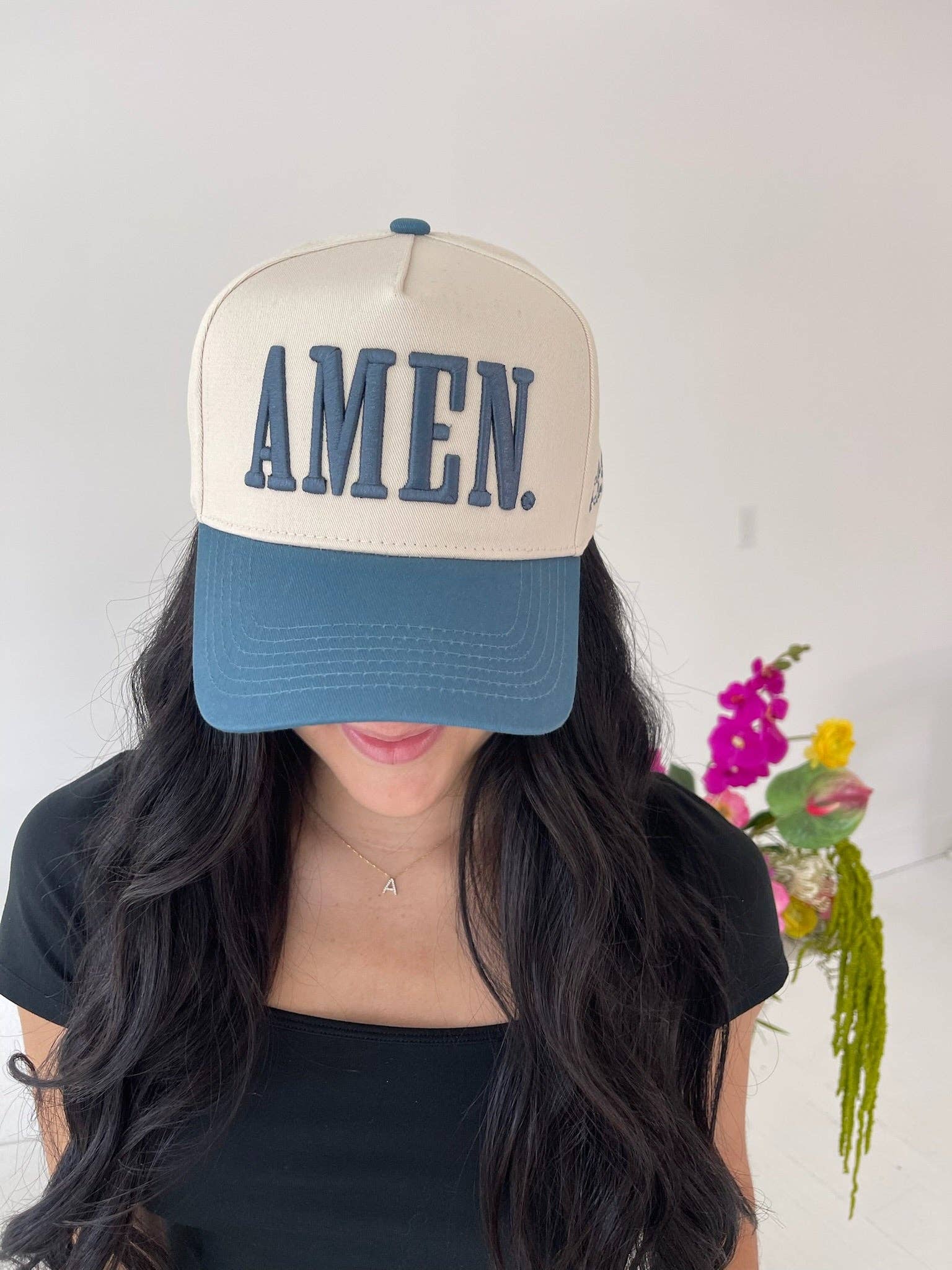 Close up of AMEN embroidery on slate blue trucker hat