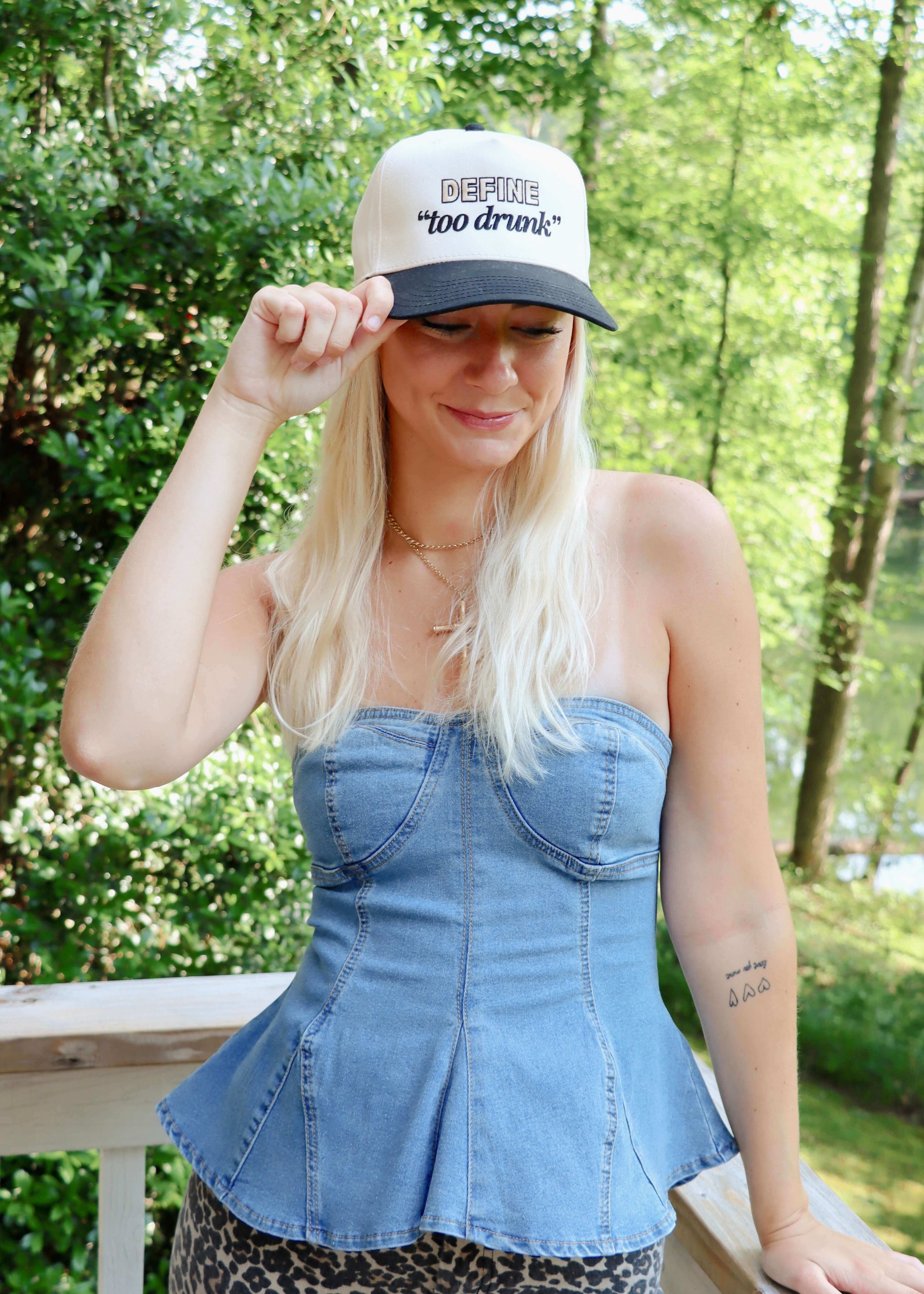 Close up of Define Too Drunk embroidery on trucker hat