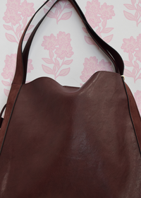 Burgundy shoulder bag featuring spacious interior design