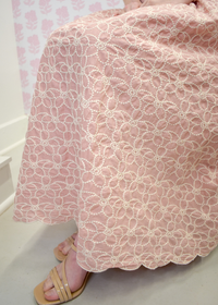 Soft blush midi dress with intricate embroidery and flowing skirt