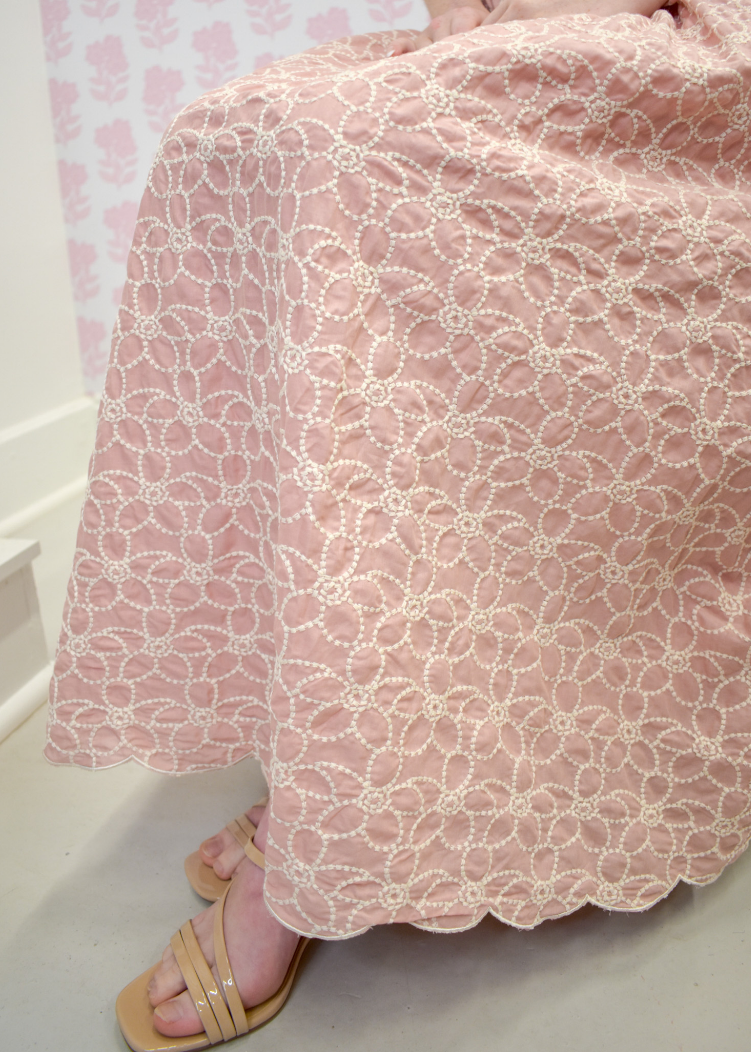 Soft blush midi dress with intricate embroidery and flowing skirt