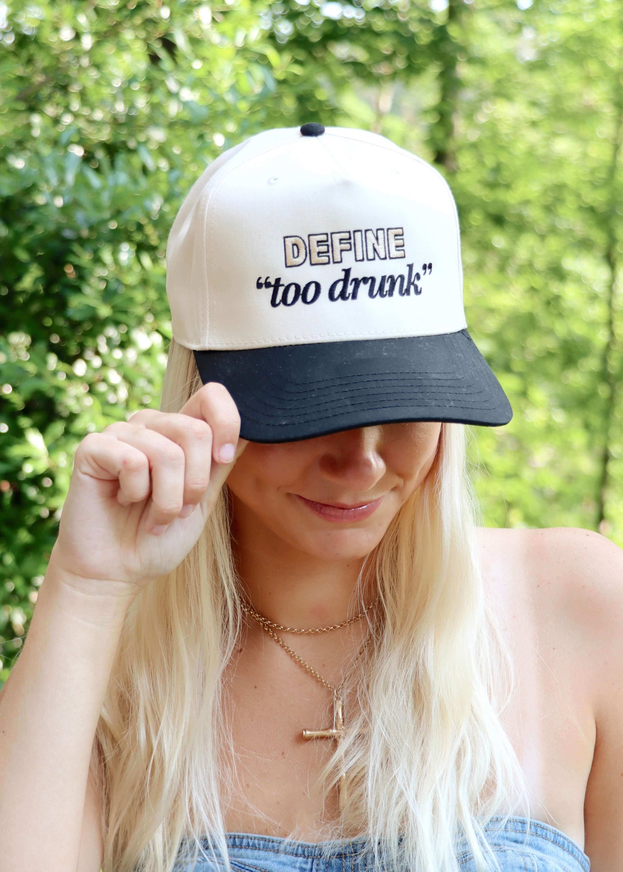 Black and natural snapback trucker hat with Define Too Drunk embroidery