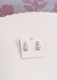 Pearl drop earrings featuring graduated pearl sizes
