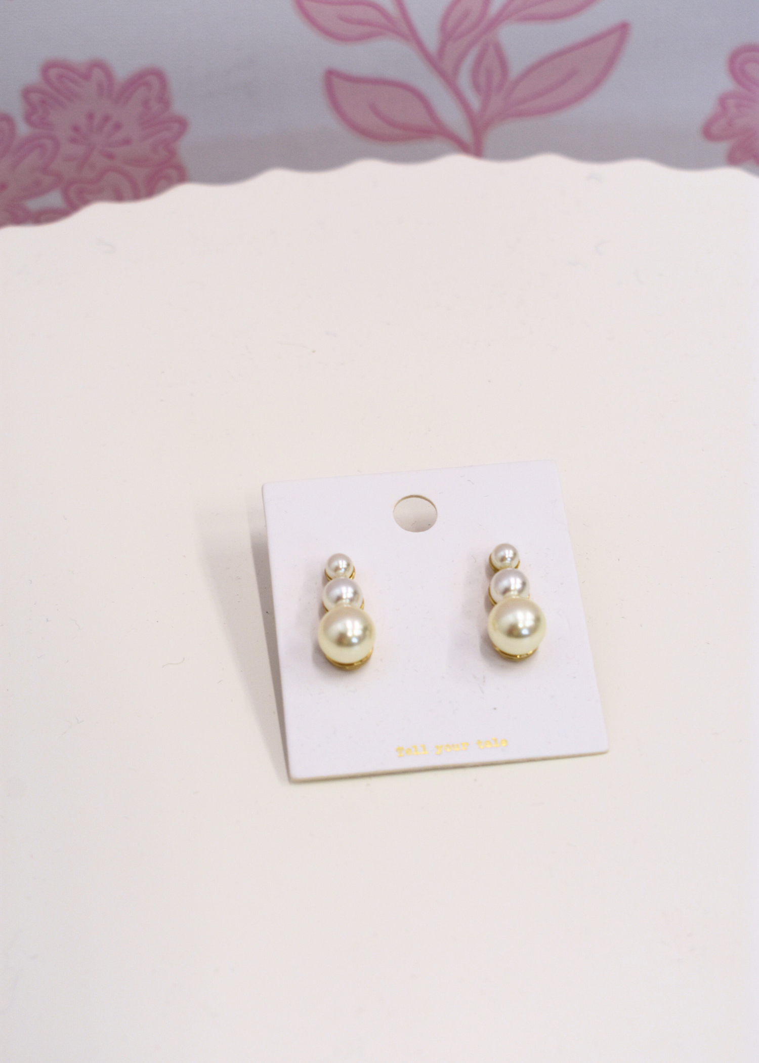 Pearl drop earrings featuring graduated pearl sizes