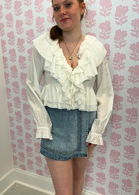 Outfit view of light wash denim mini skort with built in shorts