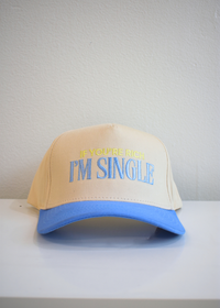 Front view of I'm Single periwinkle and natural vintage trucker hat with embroidered slogan