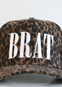 Close up of BRAT embroidery on leopard print trucker hat