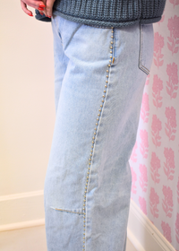 Side view of light wash studded crop flare jeans