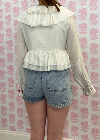 back view of Light wash denim mini skort styled with casual outfit