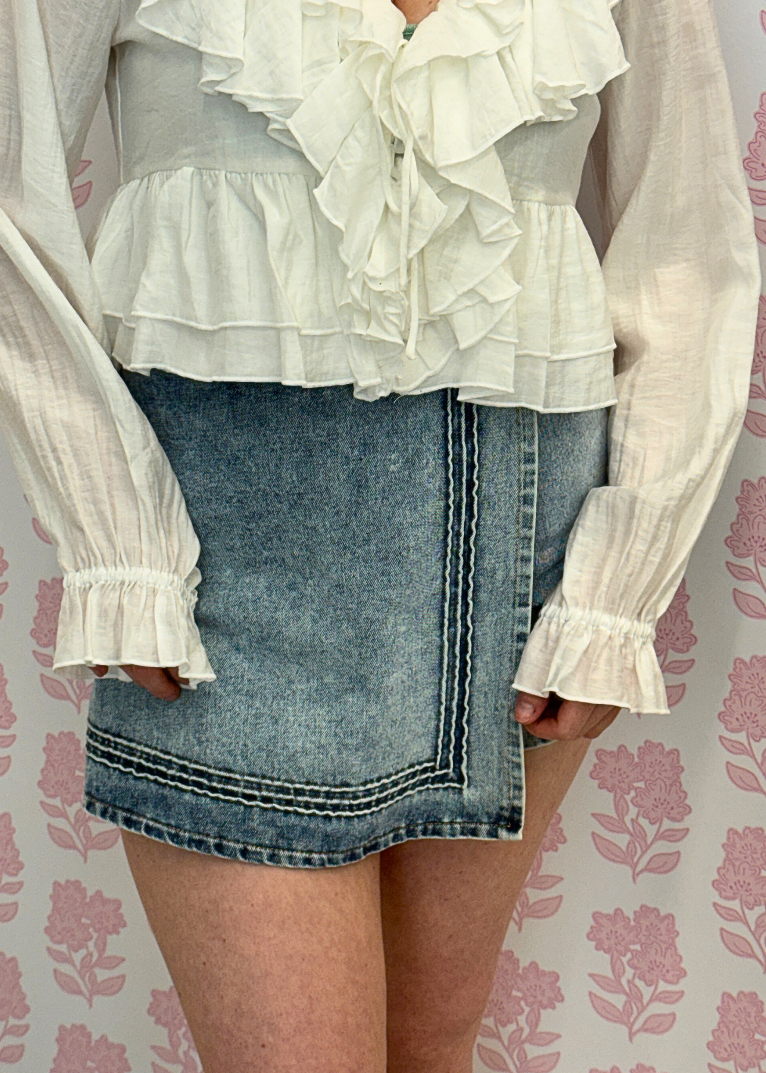Front view of Maggie high waisted light wash denim mini skort