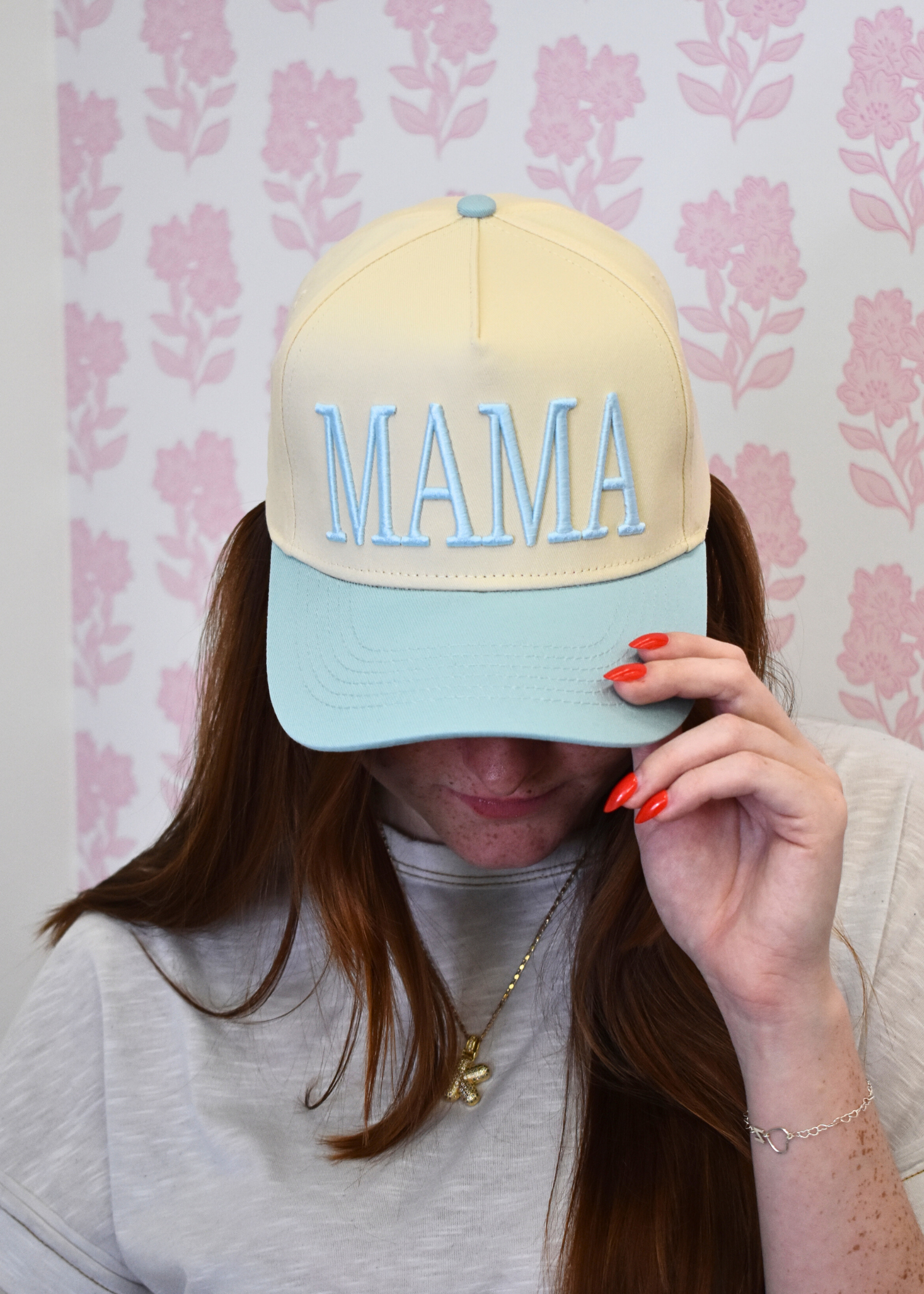 Front view of MAMA baby blue vintage trucker hat with embroidered design