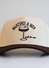 Close up view of Martinis and Men brown and natural vintage trucker hat with embroidered martini glass design