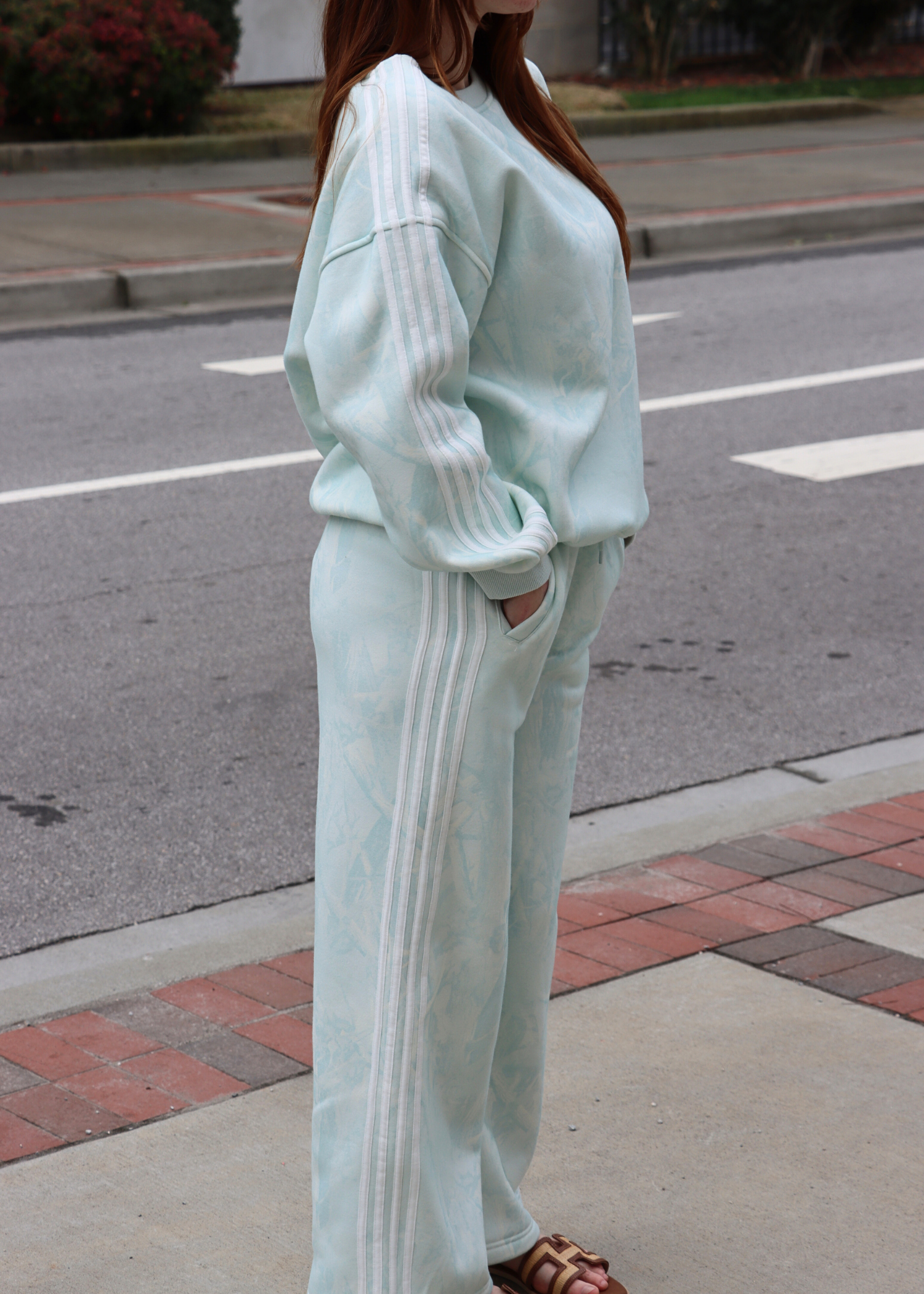 Side view of mint camo sweatpants with stripe detail