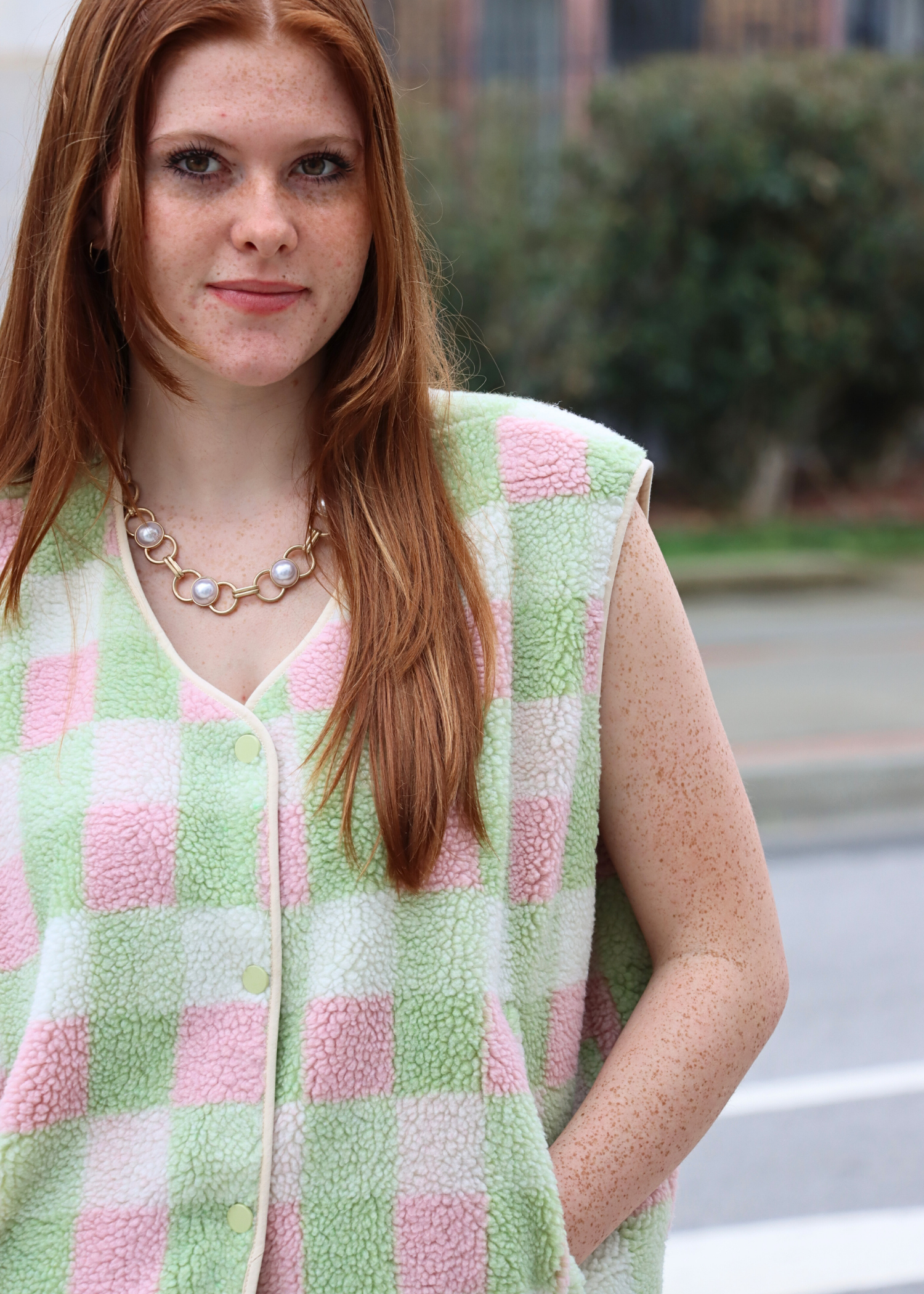 Close up of pastel multi color gingham pattern on vest