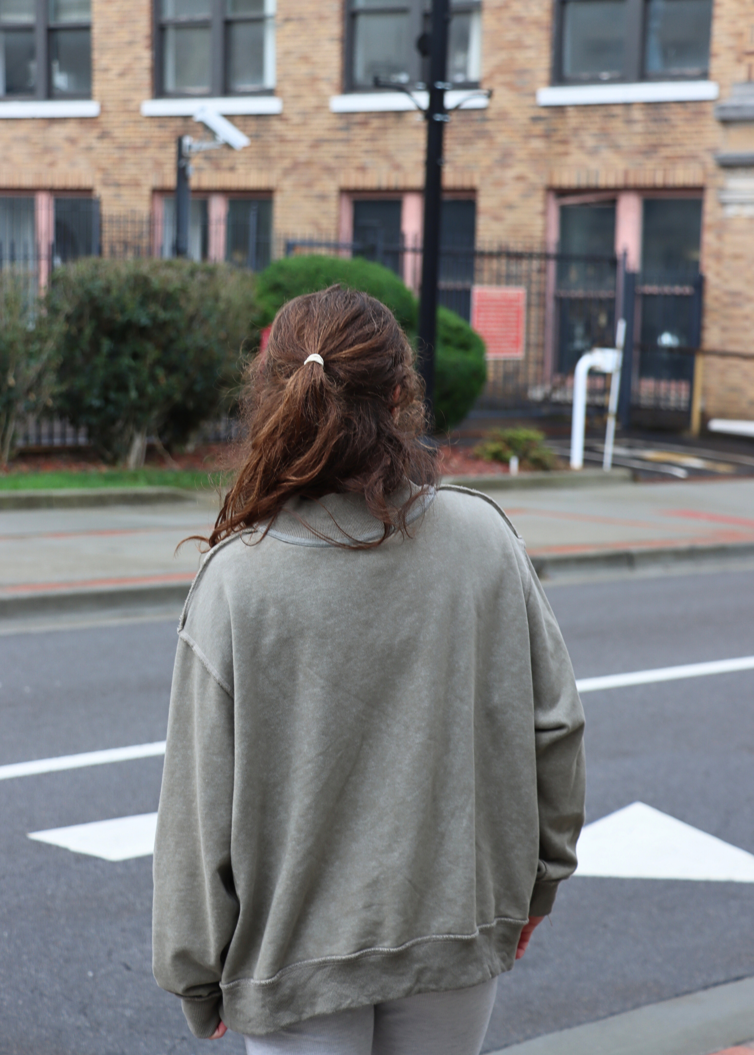 Back view of vintage wash olive mock neck sweatshirt