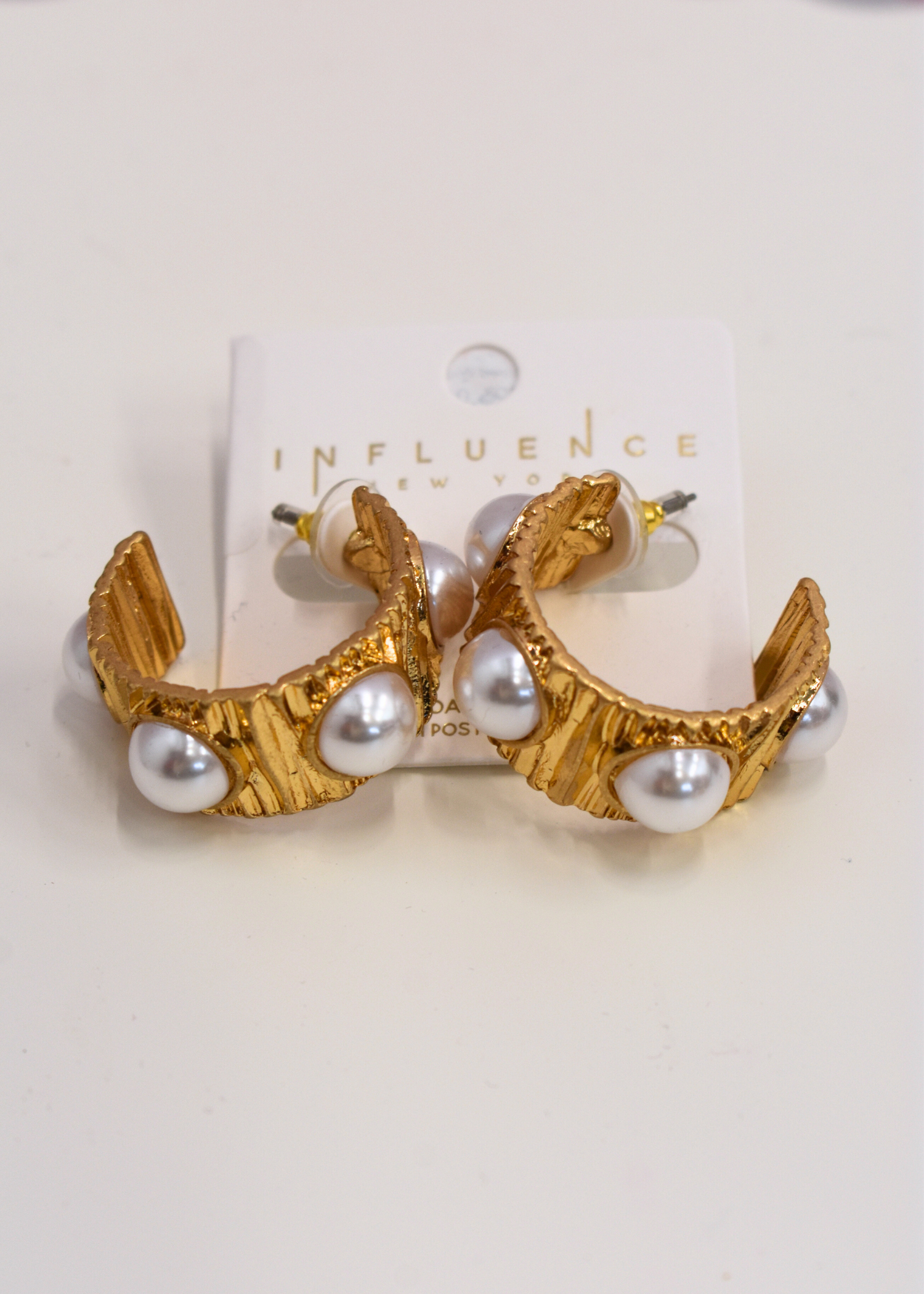 Textured vintage gold hoop earrings featuring pearl accents